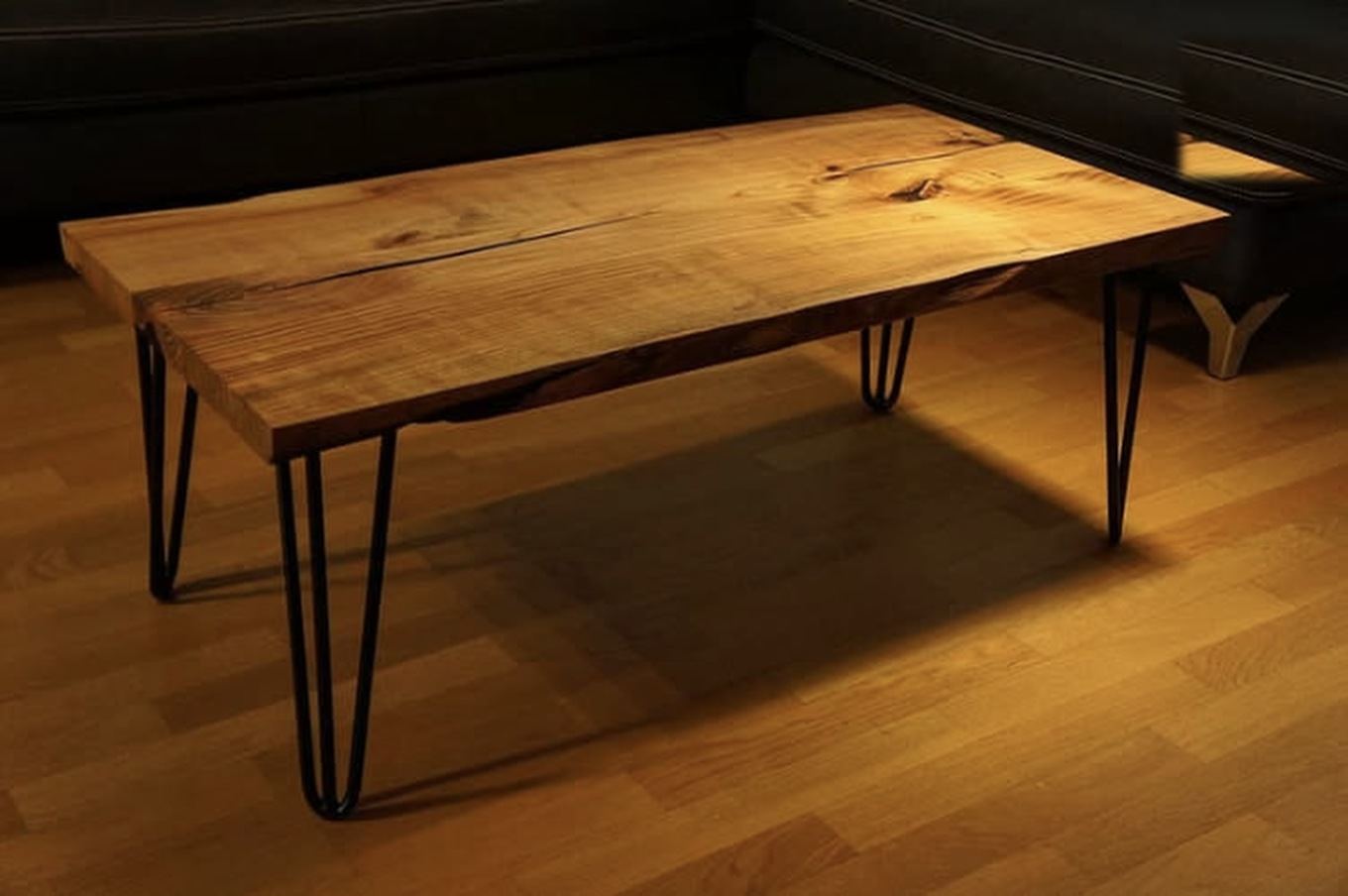 Live-edge cherry coffee table with a black-filled knot, on black hairpin legs