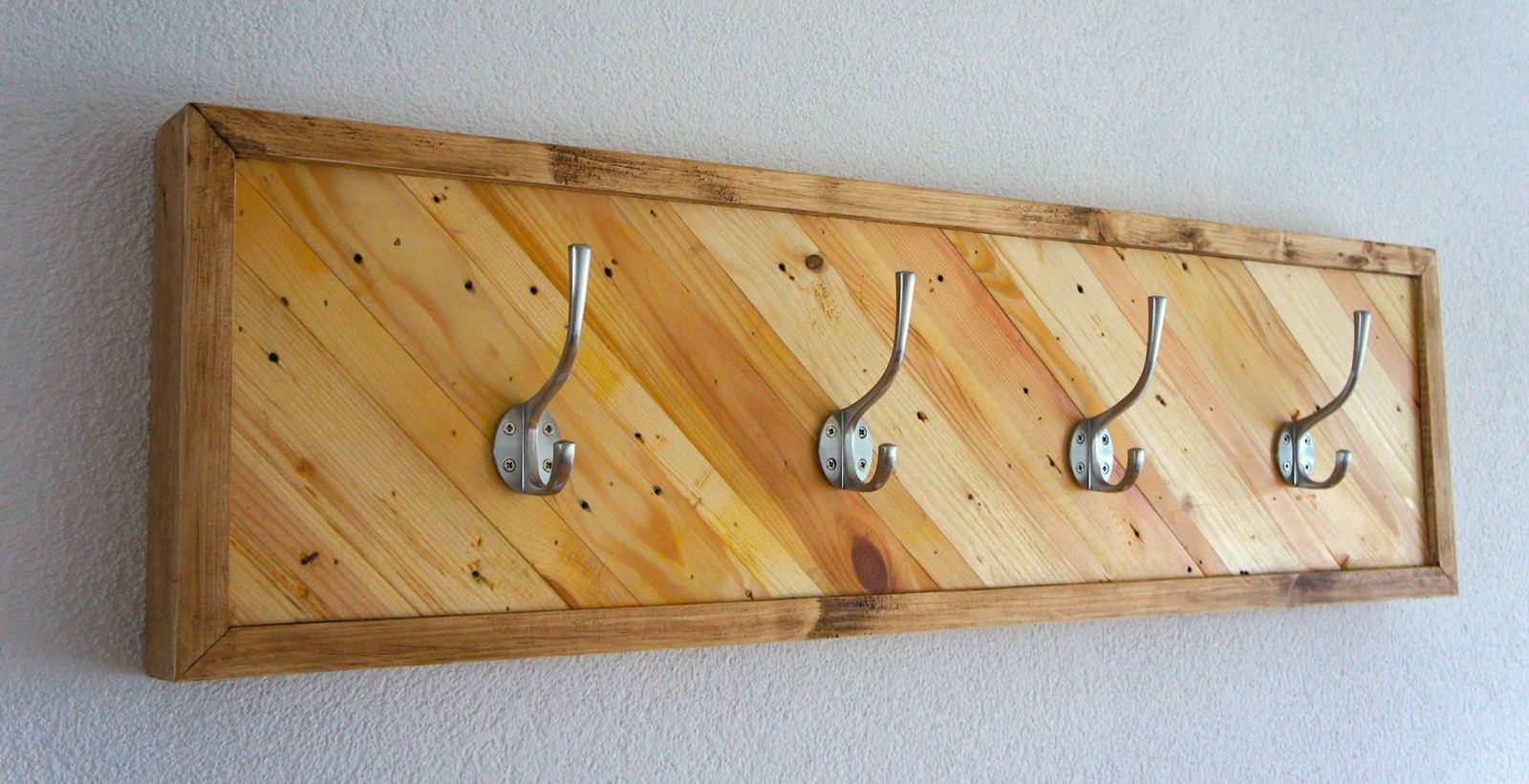 Framed coat rail with diagonal reclaimed pine boards and four steel hooks