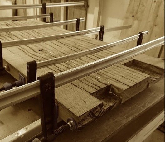 Reclaimed oak boards glued up under sash clamps
